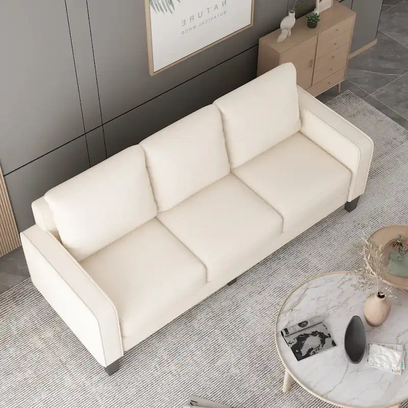 Canapé en tissu beige avec accoudoirs carrés et dossier capitonné